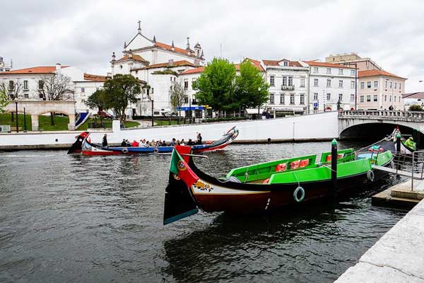 A brightly painted moliceiro boat waiting to take tourists on a cruise