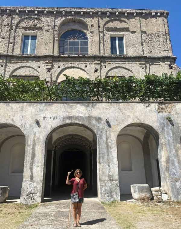 Cindy standing in front of the castle that bears her name in Salerno